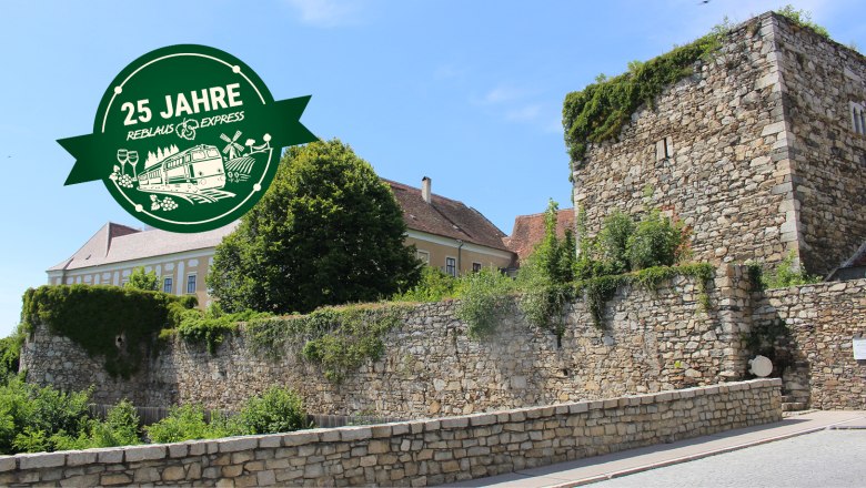 Blick auf das Raaber Tor in Drosendorf, © Mathias Häckel Stadtmauer in Drosendorf und einem Jubiläumslogo.